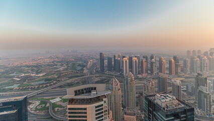 Panorama of Dubai Marina with JLT skyscrapers and golf course timelapse, Dubai, United Arab Emirates.