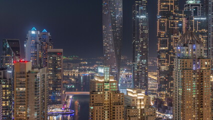 Fototapeta na wymiar Skyscrapers of Dubai Marina near intersection on Sheikh Zayed Road with highest residential buildings day to night timelapse