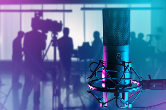 Microphone for sound recording. Film crew silhouette. Condenser microphone. Broadcast equipment. Microphone near operator with camera. TV and radio equipment. Micro for radio podcasts