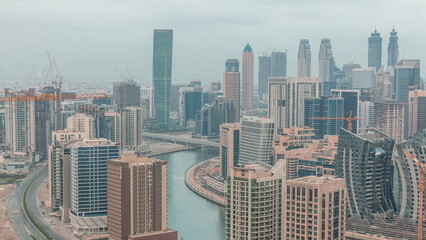 Fototapeta na wymiar Skyline with modern architecture of Dubai business bay towers night to day timelapse. Aerial view