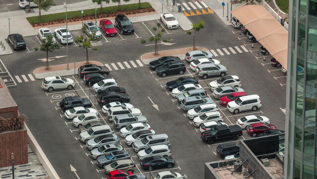 Aerial view of a parking lot with many cars in rows timelapse