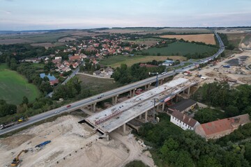 Obraz premium D7 motorway is a highway northwest from Prague to Chomutov and the German border,building of new highway by Louny city,speed road construction work with bridges and modern infrastructure,Czech-Europe