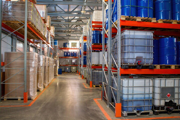 Large storehouse. Multi-tiered racks for address storage. Warehouse with boxes and barrels....