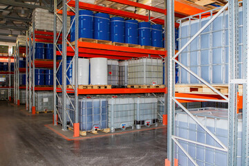 Storage area. Chemical factory warehouse. Pallet racks with barrels. Building chemical plant from...