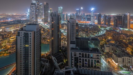 Aerial panoramic view of a big futuristic city all night timelapse. Business bay and Downtown