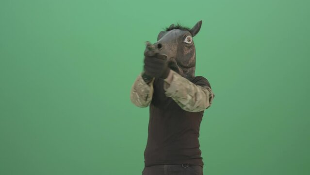 Funny Horse Man in Mask shooting enemies isolated on green screen 4K Video Footage