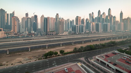 Dubai marina tallest block of skyscrapers night to day timelapse.