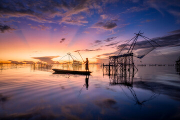 Fisherman go fishing in the morning during sunrise time at Pak Pra, Phatthalung in Thailand. 