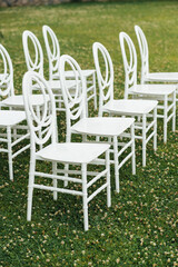 Chairs set up by the green lawn in preparation for a wedding reception