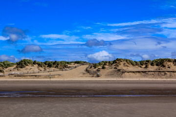 The view of the Formby Beach (Victoria Road Beach) or Formby Dunes in Liverpool, UK at sunny day. City in Merseyside county of North West England. Including the famous sand dunes. Nature, travel scene