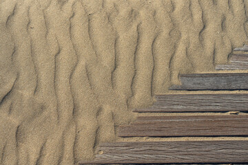 Planks covered with sand waves