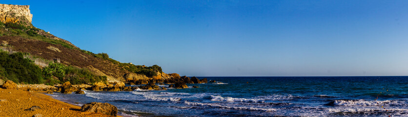 Serene Beach and Rocky Cliff
