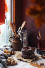 Chocolate donuts in an autumn style still life