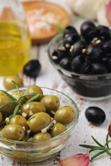 Black and green olives in glass bowls