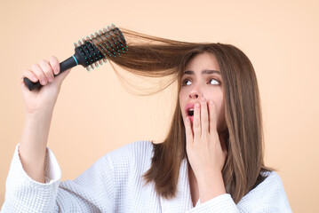 Hair loss woman with a comb and problem hair. Hairloss and hairs problems. Sad girl with damaged hair. Haircare and loss hair problem. Tangling hairs. Girl combing damaged hairs. Alopecia, dandruff.
