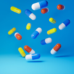 Falling antibiotic pill capsules isolated over blue background. Healthcare and medical concept. 3D rendering.