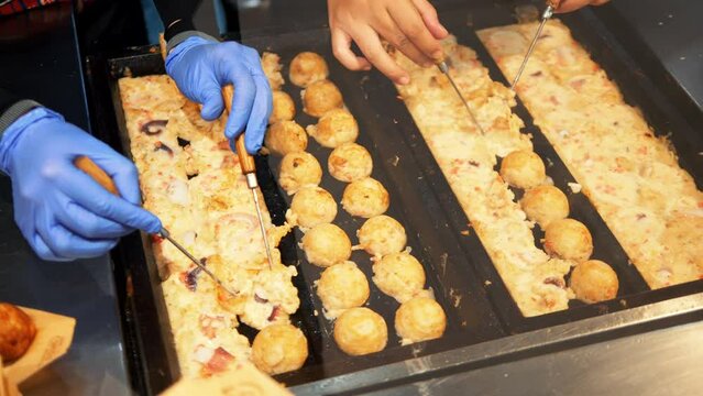 Asian street food: process of making traditional Thai Khanom Krok dessert, high quality 4K slowmotion hedonism concept footage, Thailand.