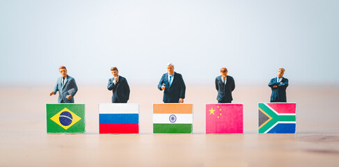 Businessmen miniature figure standing with Brazil Russia India China and South Africa flag for...