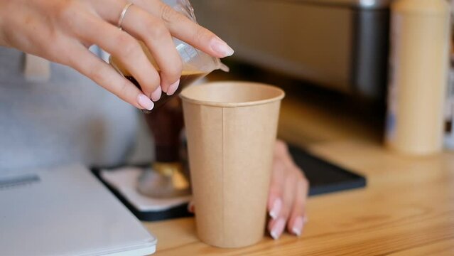 Barista woman prepares fresh morning coffee.