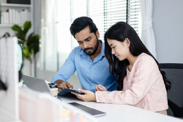 Businessman and businesswoman professional working using tablet brainstorming planning idea project. Female manager presentation with computer for male worker inside office listens to meeting report.