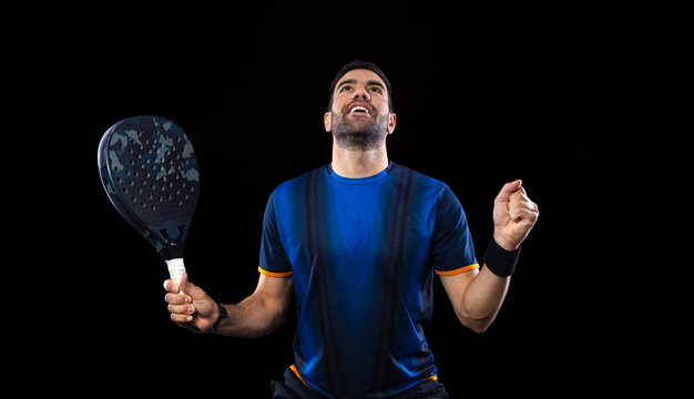 Padel tennis player. Man athlete with paddle tenis racket on black background.