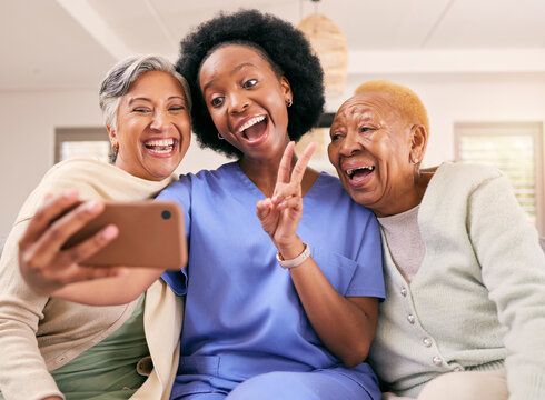 Selfie, caregiver and senior women with peace sign for social media, online post or profile picture on sofa. Retirement, nursing home and nurse with elderly people take photo for happy memories