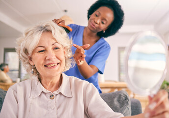 Caregiver brush hair of happy senior woman in the living room of the modern retirement home for...