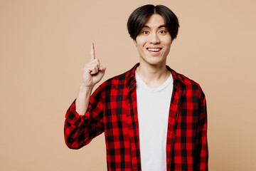 Young proactive man of Asian ethnicity he wear red checkered shirt casual clothes holding index...
