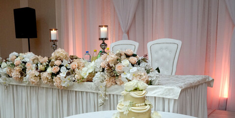 Wedding flower composition for bride and groom table, decorative flowers on the wedding table