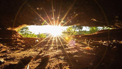 sun rays through a rock in the Palatinate Forest
