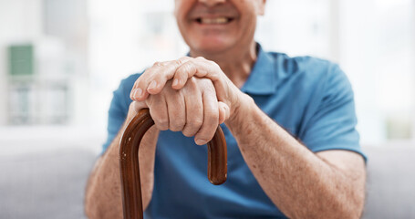 Walking stick, hands and happy elderly man with wooden cane on sofa for balance, support and...