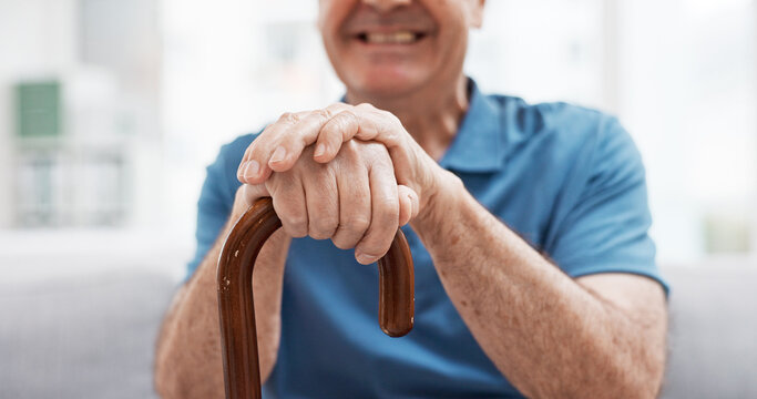 Walking Stick, Hands And Happy Elderly Man With Wooden Cane On Sofa For Balance, Support And Mobility. Walk, Aid And Old Male At Senior Care Facility With Disability, Dementia Or Chronic Arthritis