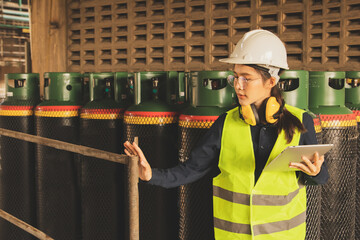 Asian female safety officer inspects the engineering department of refrigerant storage ammonia...
