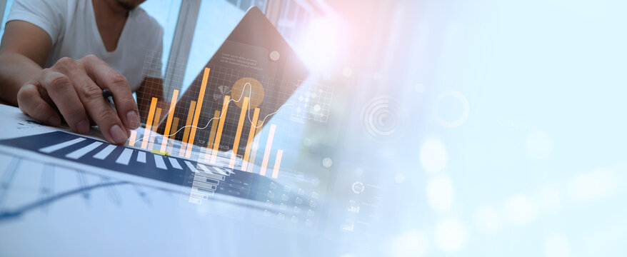 Businessman pointing arrow graph growth and financial network connection, analysing data to increase sales and revenue profit to achieve business investment goal in global economic situation.