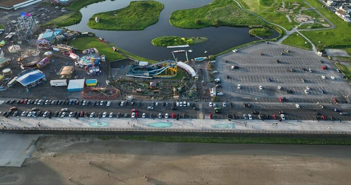 View of the amusement park, and a large car park along the coast 4k