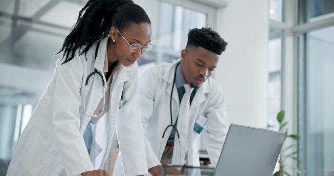 Computer, planning and team of doctors in an office in the hospital for a diagnosis treatment. Healthcare, discussion and young African medical workers doing research on a computer in medicare clinic