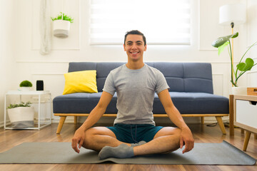 Fototapeta na wymiar Caucasian man doing yoga using a mock-up t-shirt