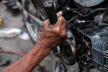 Motorcycle mechanics are assembling the motorcycle engine clutch assembly and maintenance.