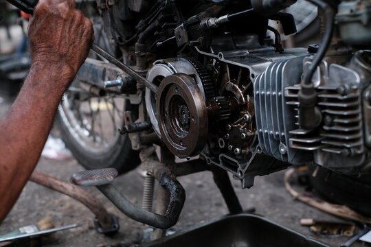 Motorcycle mechanics are assembling the motorcycle engine clutch assembly and maintenance.