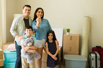 Cheerful family of four moving and unpacking boxes