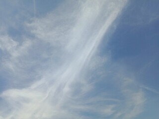 Blue sky and white clouds forming abstract or irregular shape