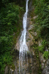 Fototapeta na wymiar Beautiful waterfall Men's Tears on the territory of the Ritsa Reserve in the Gudauta region of Abkhazia
