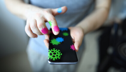 Male hand hold smartphone with coronavirus covid 19 closeup background. How to protect yourself antivirus concept