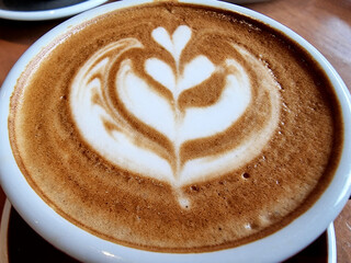 Close-up a cup of hot art latte coffee background.