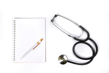 Doctor desk.Stethoscope notebook and pen on white background