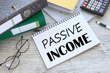 passive income two office folder gray notepad. text on the page
