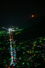 Moon over city landscape