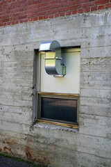 A metal vent in an abandoned building window