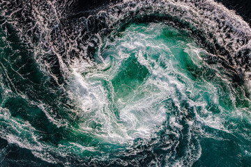 Blue waves of water of the river and the sea meet each other during high tide and low tide.