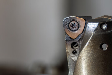 Close up scene the wear at the chip insert on indexable tool.